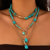 Boho halsband med western-berlocker Guld och turkos