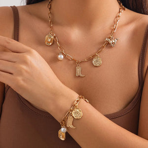 Chunky guldhalsband och armband med western-berlocker Guld